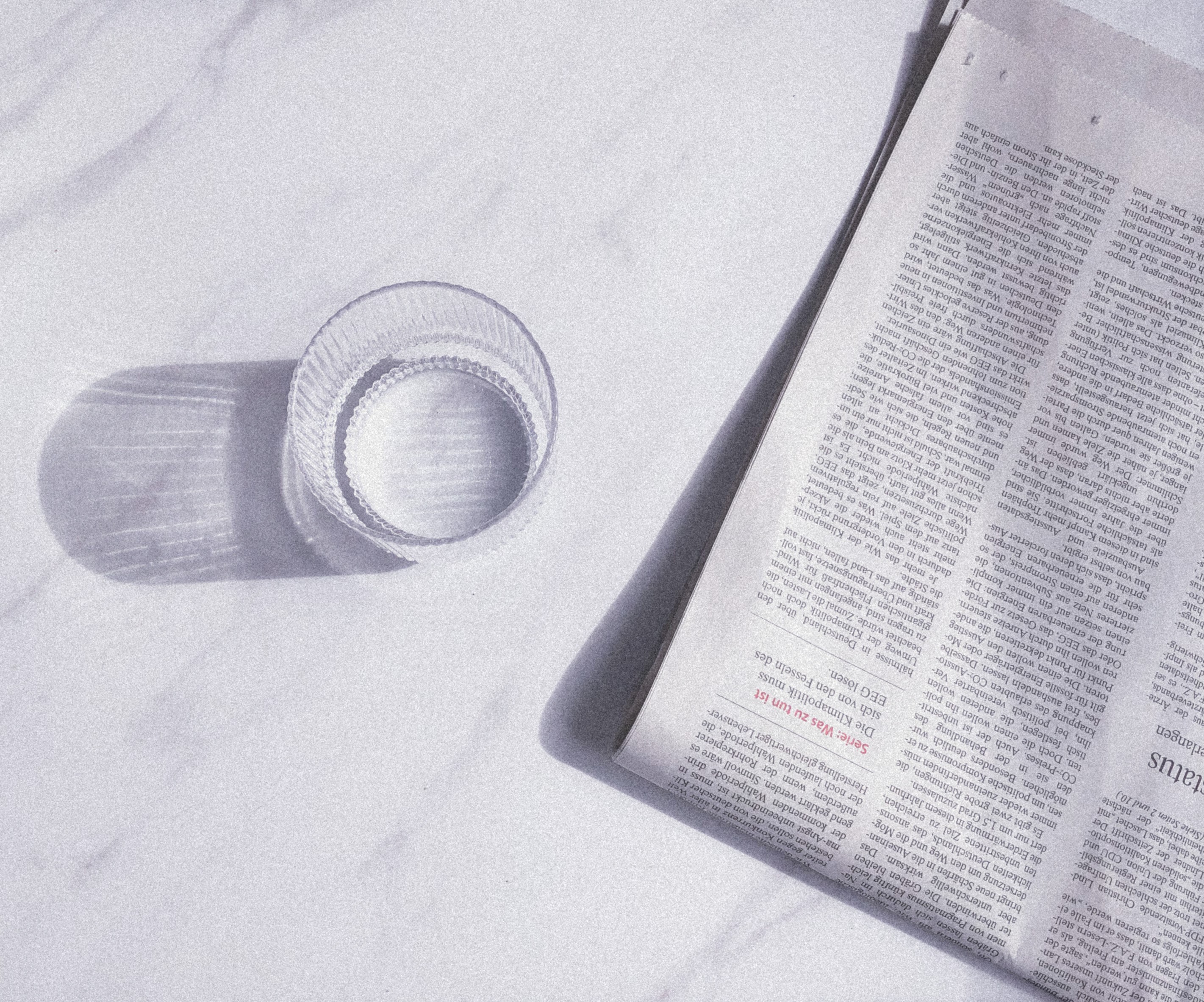 an image of a glas and a newsaper